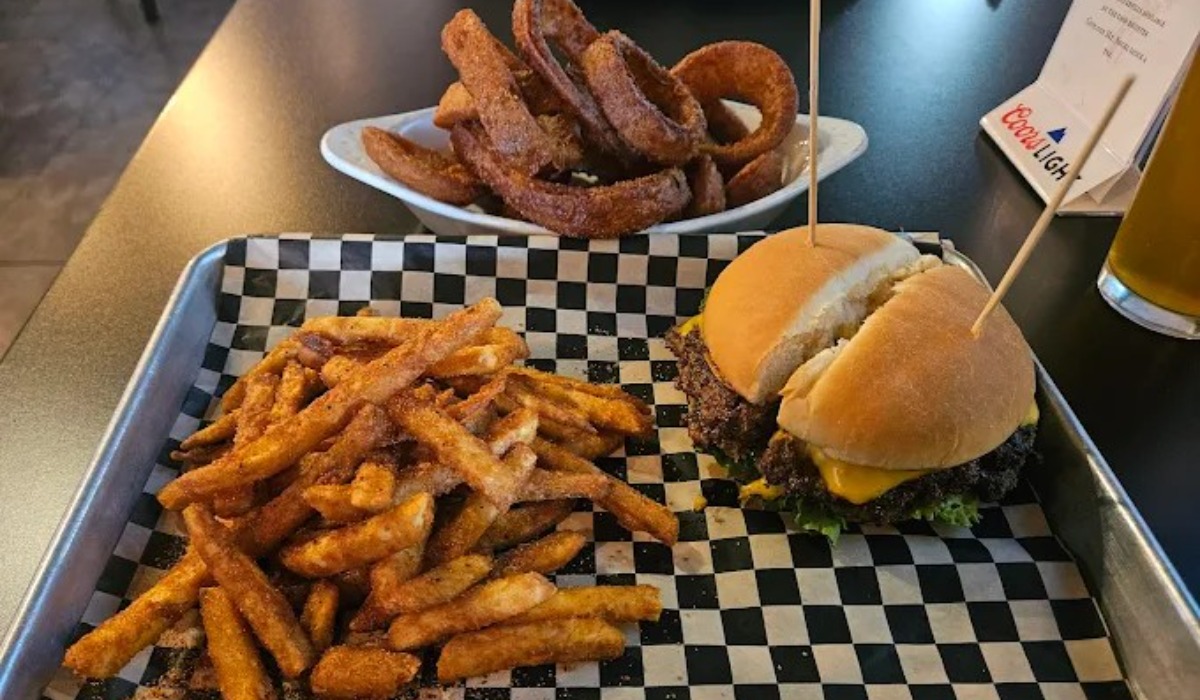 burger fries and onion rings from pub 210 east