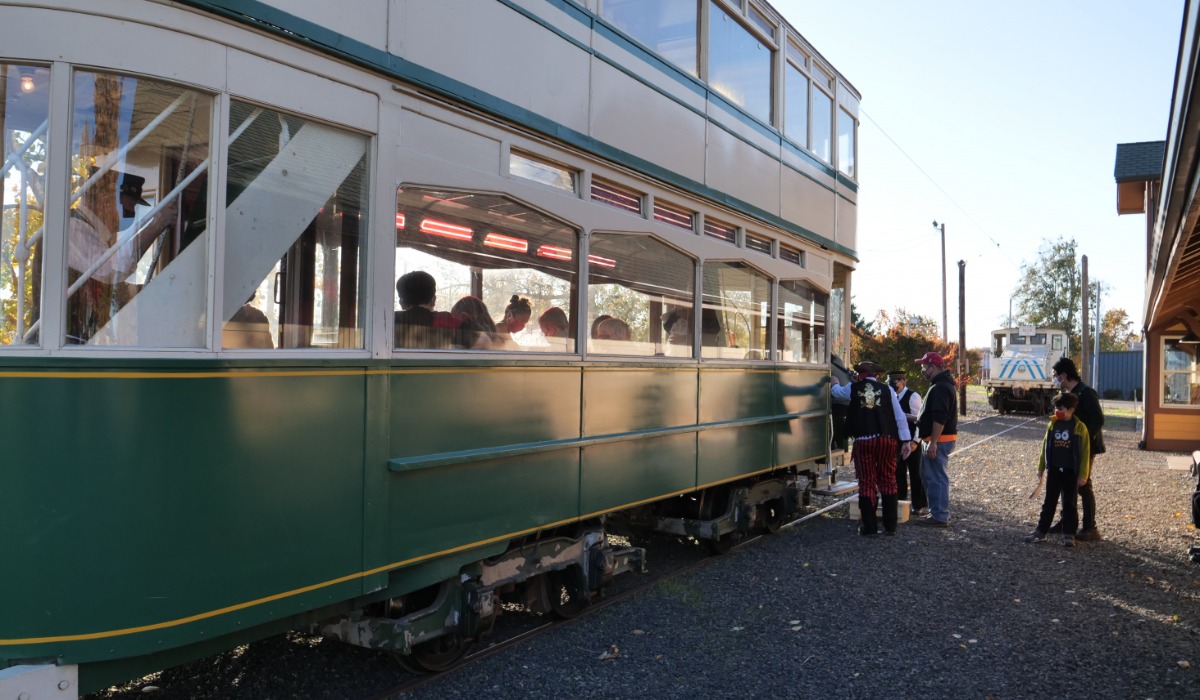 Guests board a vintage trolley during Powerland Halloween in Brooks.